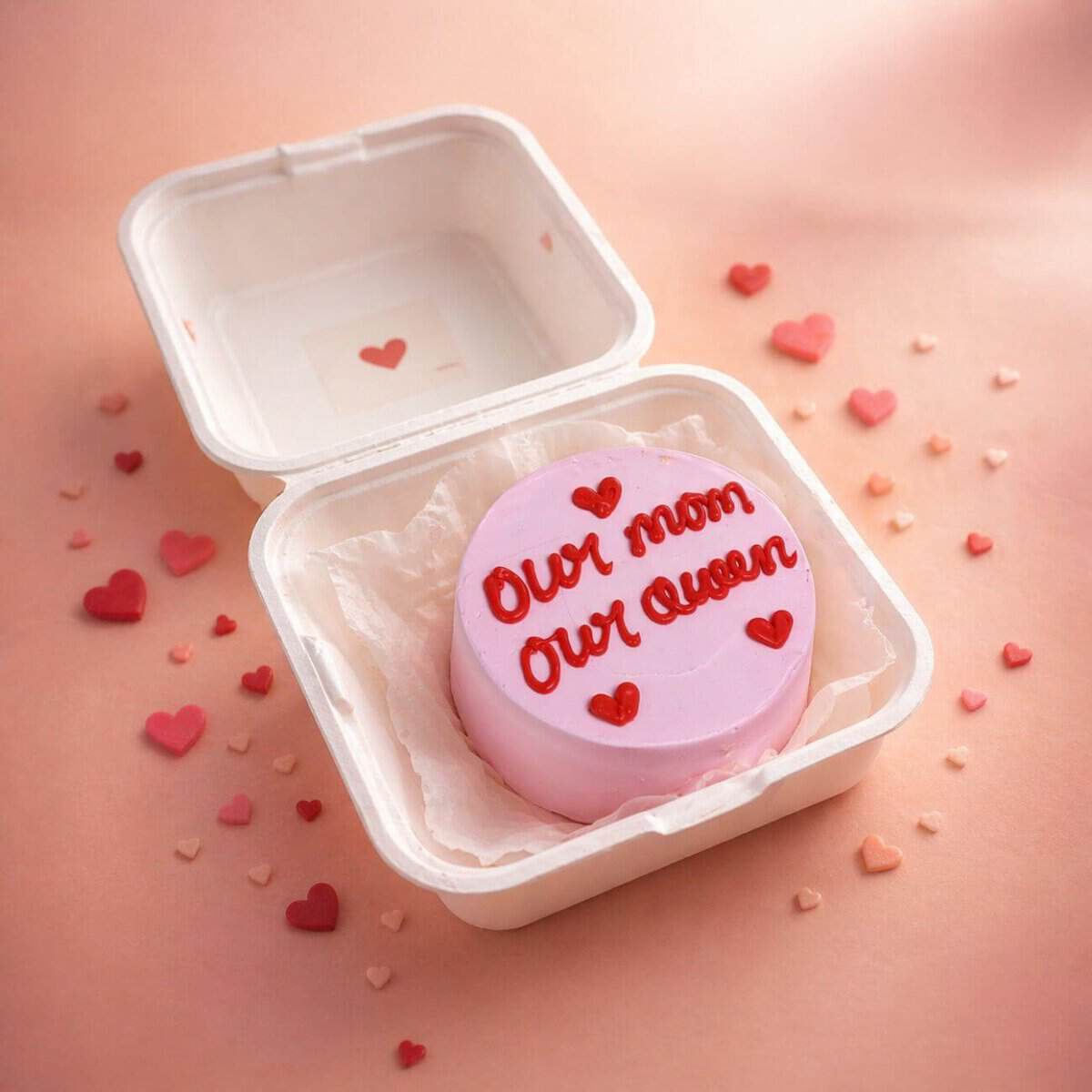 Delicate pink cake with "Our Mom Our Queen" message, perfect for Mother's Day in Chennai. our mom our queen