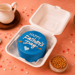 Blue Father's Day cake in a white box with heart and arrow decorations in Chennai. happy fathers day bento cake, father's day bento cake, fathers day cake, dad bento cake, cake for dad, fathers day special cake, happy fathers day cake, best dad cake, personalized fathers day cake, customized cake for dad, fathers day cake delivery chennai, korean bento cake, fathers day gift cake, dad birthday cake, cake for father, mini fathers day cake, cute fathers day cake, aesthetic fathers day cake, bento cake delivery chennai, same day cake delivery chennai, best fathers day cakes in chennai, customized cake chennai, cake square, cake square fathers day cake, premium bento cake chennai, fathers day surprise cake, korean cake chennai, best dad ever cake