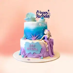 Two tier seashell princess birthday cake for girls in Chennai with a fondant girl in a purple gown, a seashell topper and blue to lilac ombre tiers from Cake Square.