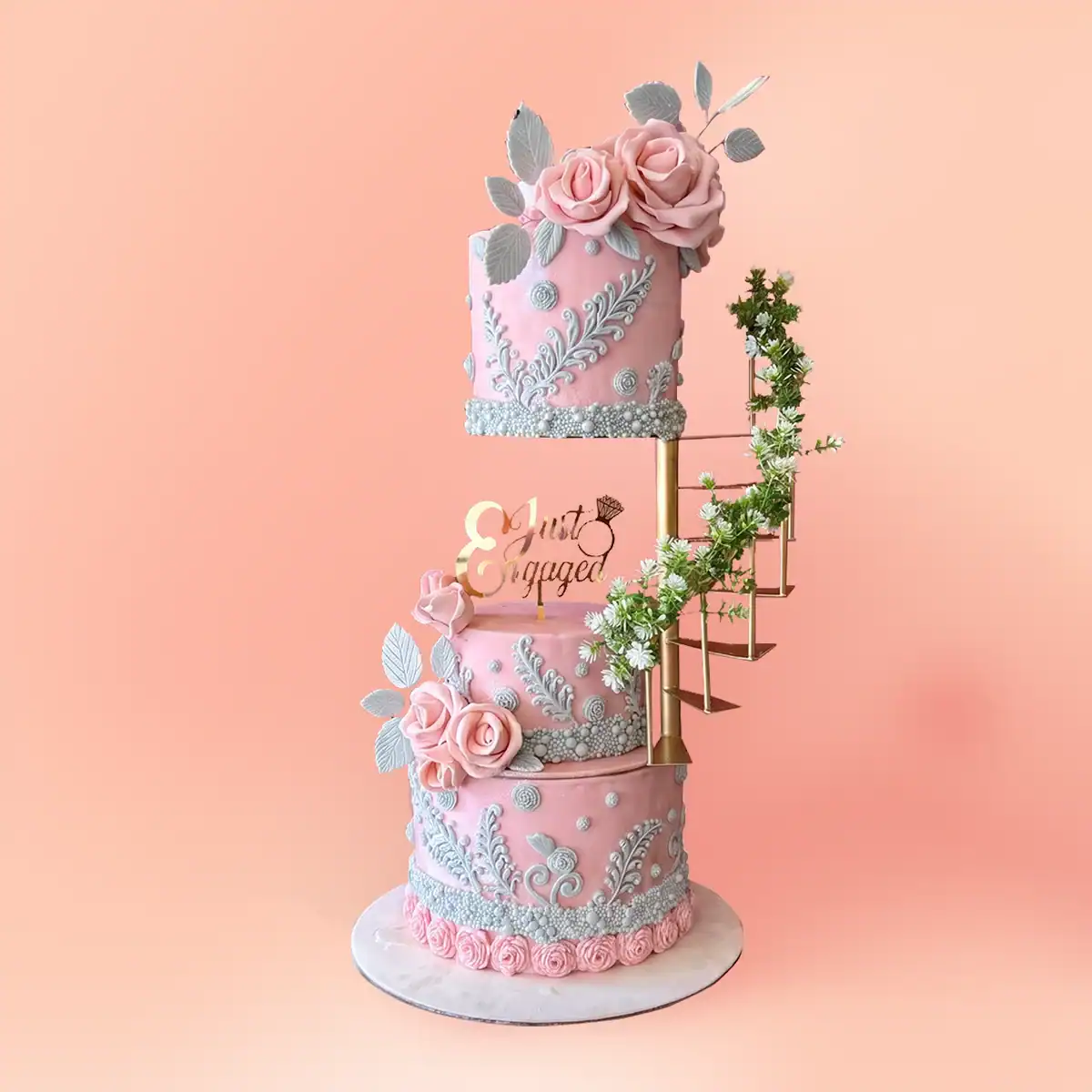 Three tier pink floral wedding reception cake in Chennai with sugar roses, hand piped lace panels and a spiral staircase, also made as an engagement cake by Cake Square.