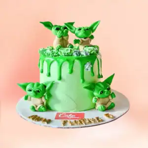 Baby Yoda theme birthday cake in Chennai, a green drip cake with four handmade Baby Yoda figures and a gold age number topper from Cake Square.