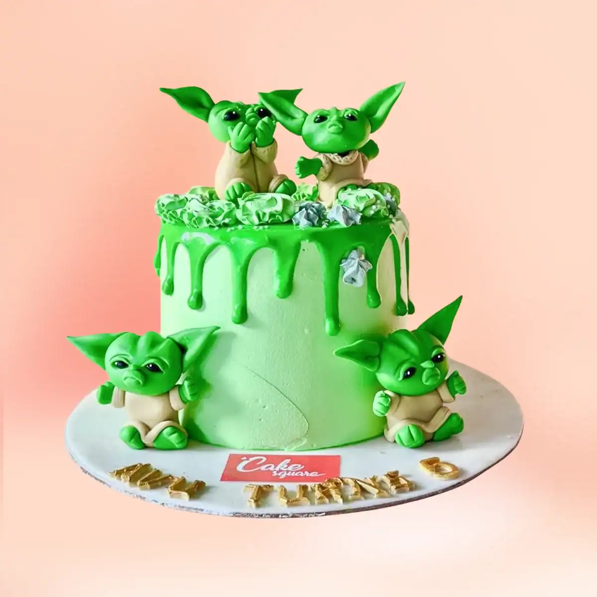 Baby Yoda theme birthday cake in Chennai, a green drip cake with four handmade Baby Yoda figures and a gold age number topper from Cake Square.