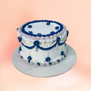 Blue and white vintage Lambeth buttercream celebration cake in Chennai with hand piped navy rosettes, gold pearls and lace detailing from Cake Square.