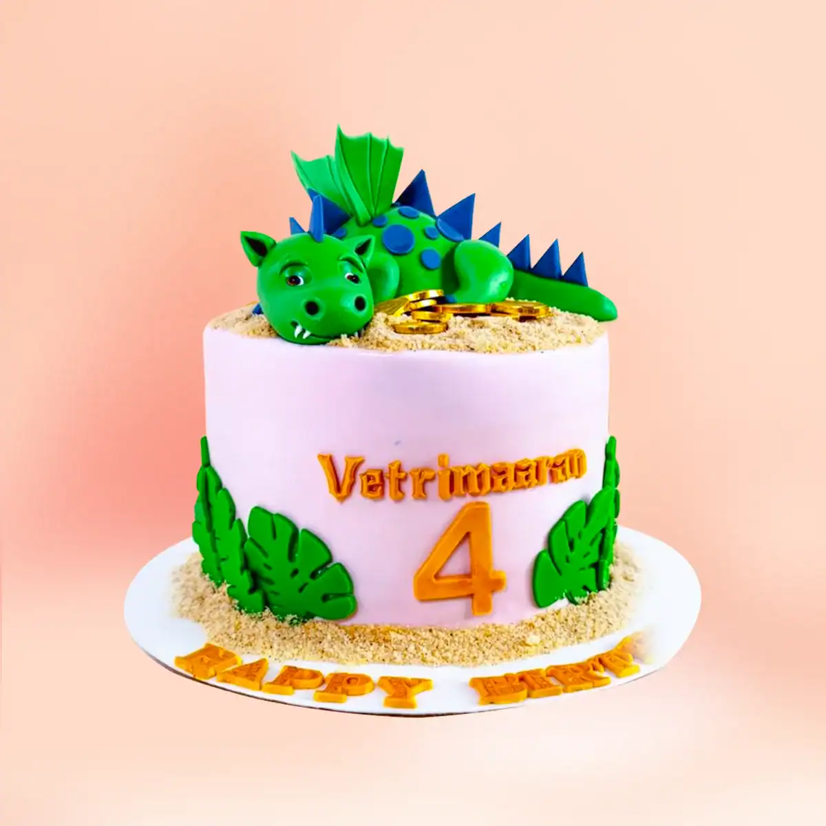 Dragon theme birthday cake in Chennai with a sleeping green dragon figure resting on gold coins, jungle leaf detailing and a custom name and age topper from Cake Square.
