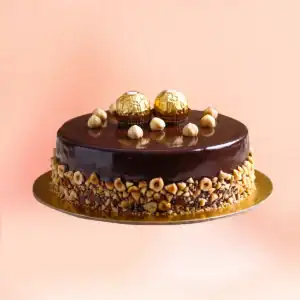 Ferrero Rocher chocolate cake in Chennai with a dark chocolate mirror glaze, whole hazelnuts and Ferrero Rocher chocolates on top, delivered in 45 minutes by Cake Square.