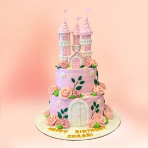 Pink princess castle theme first birthday cake in Chennai with three fondant castle towers, rose covered lilac tiers and a custom Happy Birthday name banner from Cake Square.