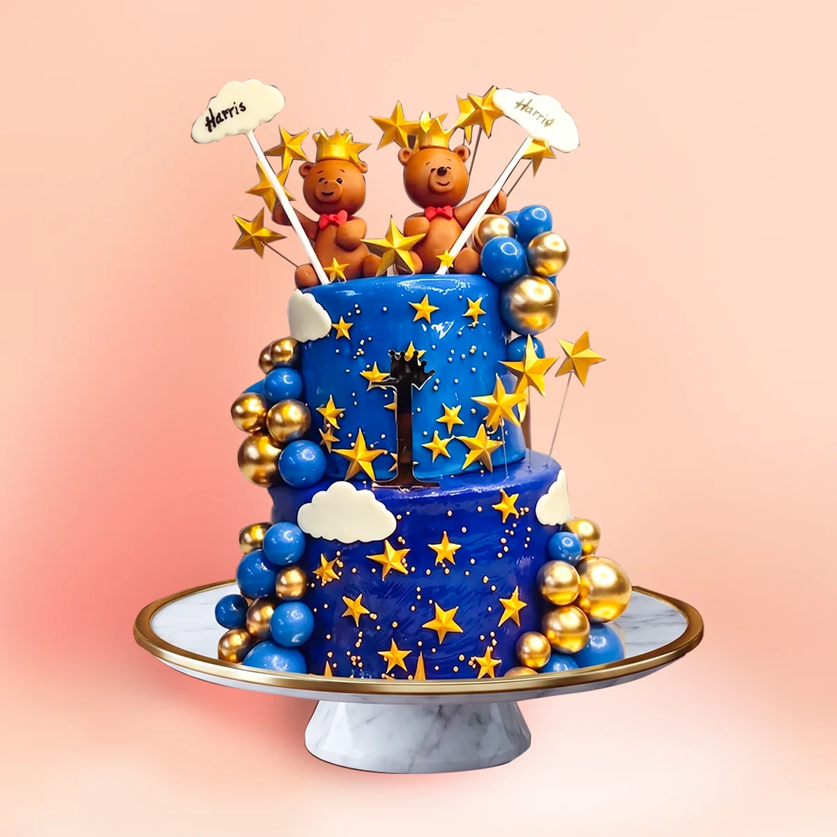 Two tier teddy and stars first birthday cake in Chennai in midnight blue with gold stars, fondant clouds and a pair of teddy bear toppers from Cake Square.