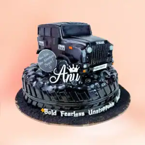 Thar SUV jeep theme birthday cake in Chennai, a fully sculpted black jeep with grille and headlights on a tyre tread base with custom lettering from Cake Square.