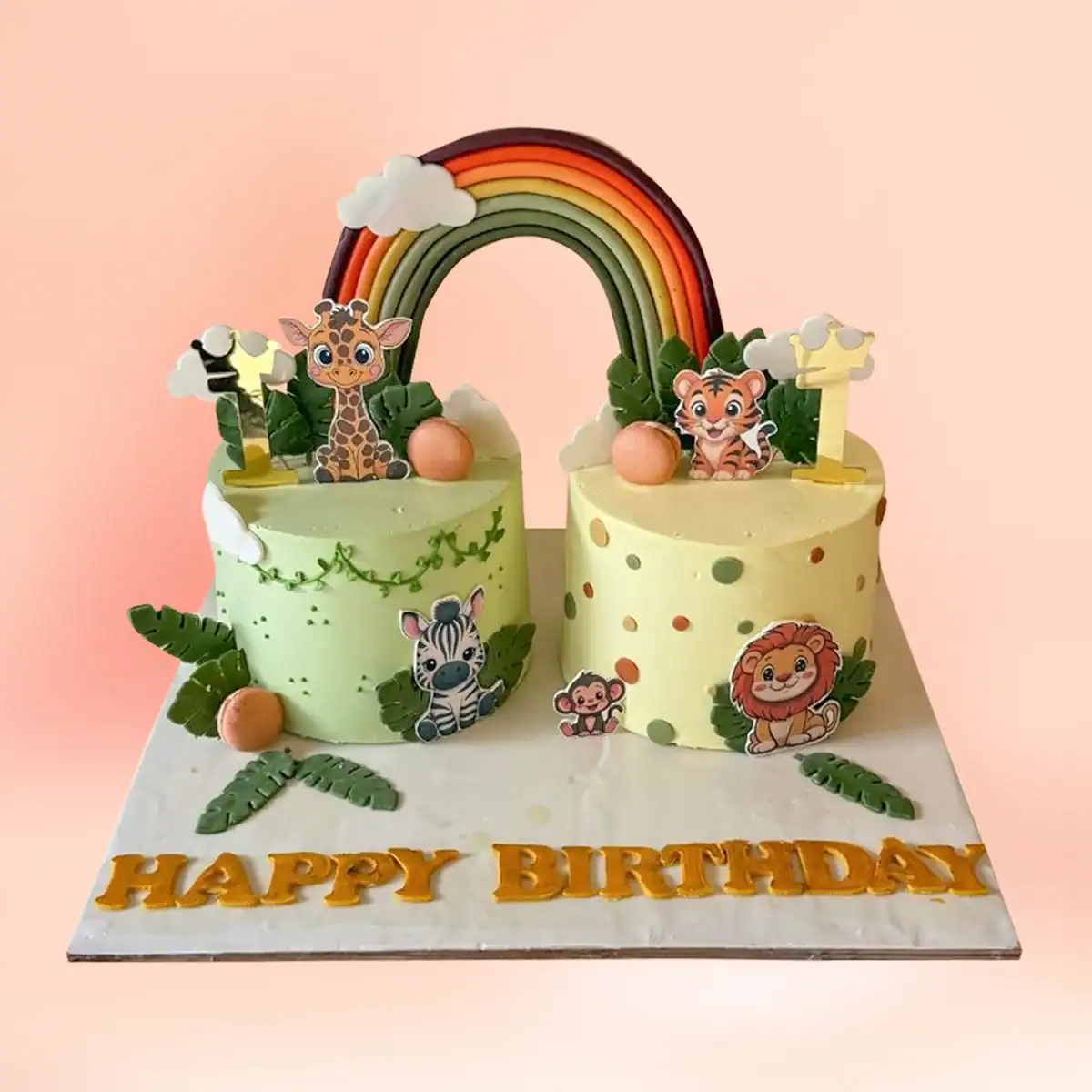 Twins jungle and rainbow theme first birthday cake in Chennai, two cakes joined by a fondant rainbow with giraffe, tiger, zebra and lion figures from Cake Square.