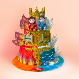 Two tier twins theme first birthday cake in Chennai with a fire and ice split design, two prince figures in gold crowns and separate name plaques for twin boys from Cake Square.